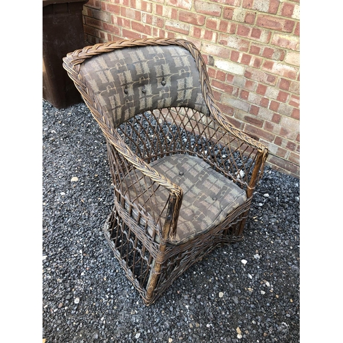 23 - A vintage wicker conservatory armchair