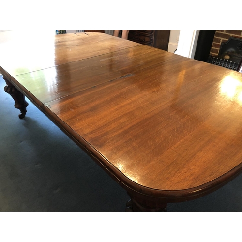 240 - A large Victorian oak wind out dining table with two extension leaves measures 276x142cm full extens... 