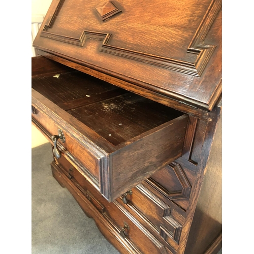 242 - An early 20th century oak bureau bookcase, a glazed cabinet top with three adjustable shelves over a... 