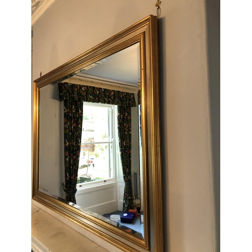 243 - A very large modern overmantle mirror with bevelled glass and a gold gilt frame 130x99