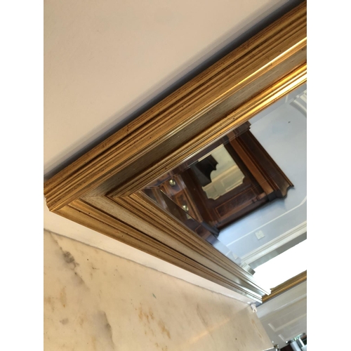 243 - A very large modern overmantle mirror with bevelled glass and a gold gilt frame 130x99