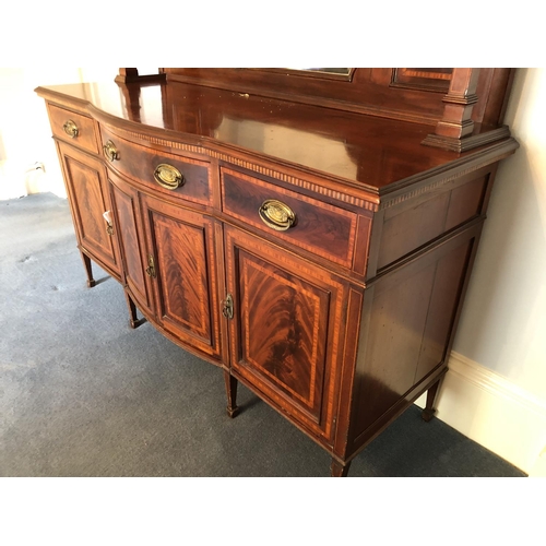 245 - An impressive large Edwardian mirror back sideboard housing three drawers over a three section cupba... 