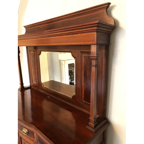 245 - An impressive large Edwardian mirror back sideboard housing three drawers over a three section cupba... 