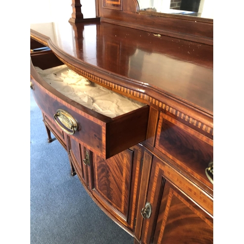 245 - An impressive large Edwardian mirror back sideboard housing three drawers over a three section cupba... 