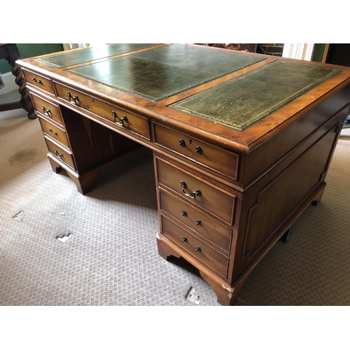 247 - A reproduction yew pedestal desk with a green leather top 151x90x75