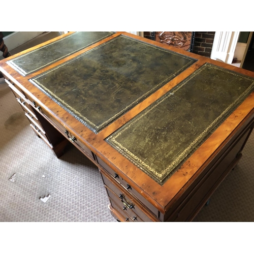 247 - A reproduction yew pedestal desk with a green leather top 151x90x75