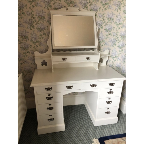 253 - A white painted kneehole dressing table with vanity mirror, two drawers and eight drawer base 121x54