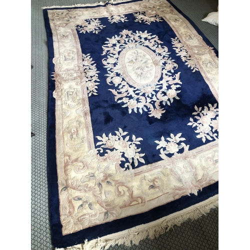 257 - A large blue patterned Chinese carpet 182x280