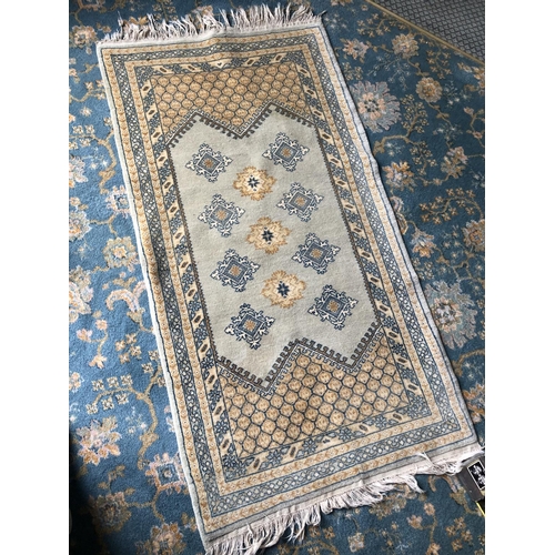 258 - A small green patterned rug 136 x70