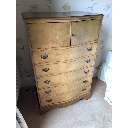 260 - A serpentine walnut gentlemans tallboy, cupboard top over five drawers 78x50x123