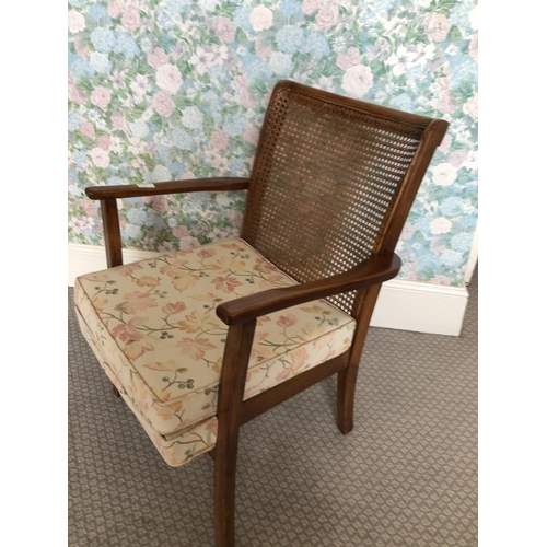 261 - A oak bedroom chair with begere back and cushion seat