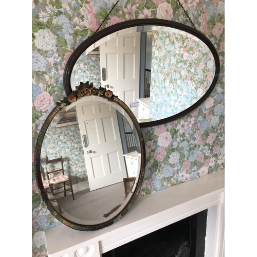 262 - A oval wall mirror with floral decoration together with another oval mirror