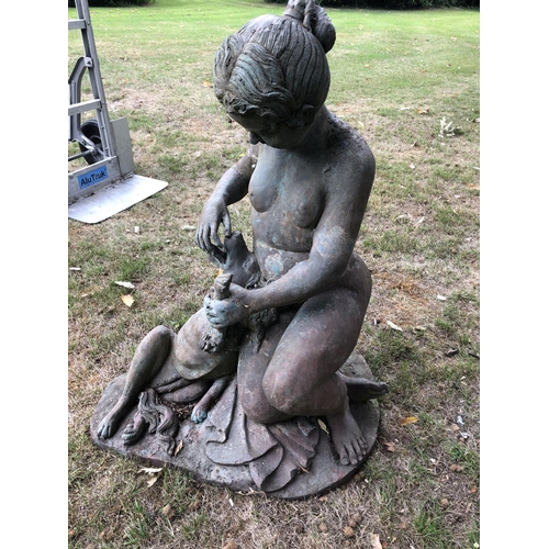 266 - A hollow cast bronze garden statue of a lady feeding a spaniel dog 80cm high