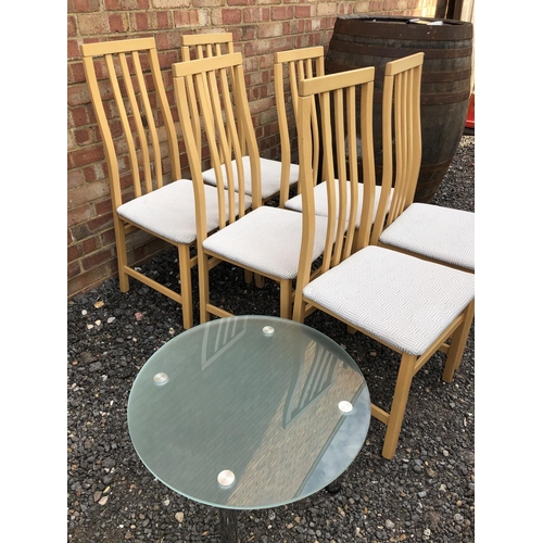 287 - A set of six modern dining chairs together with a modern glass coffee table