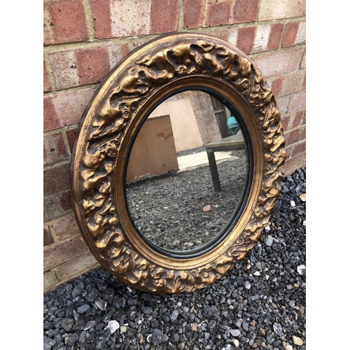 296 - An antique gold gilt oval mirror