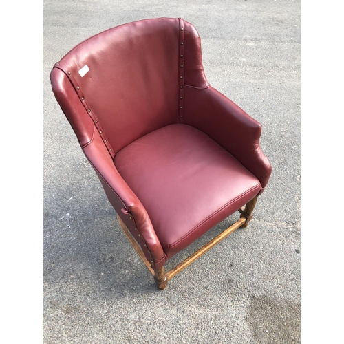 314 - A oak framed office chair with red vinyl upholstery