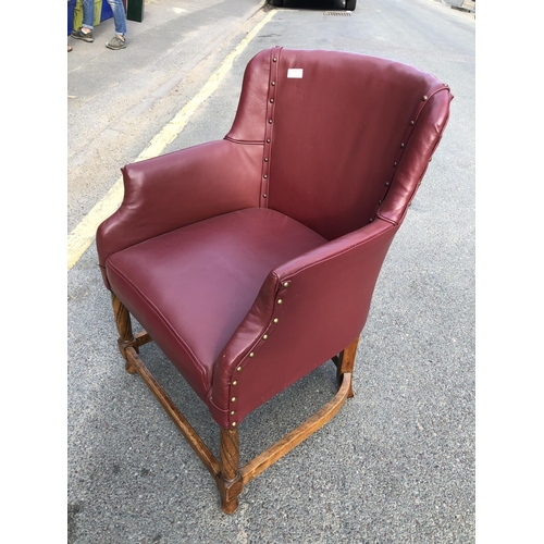 314 - A oak framed office chair with red vinyl upholstery