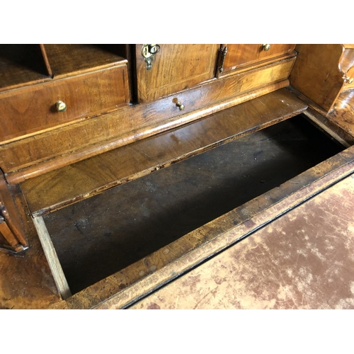 325 - A Georgian walnut bureau with a drop down front with a fitted interior above two short and two long ... 