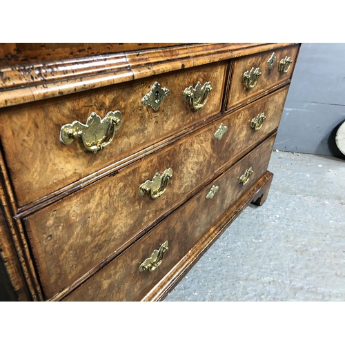 325 - A Georgian walnut bureau with a drop down front with a fitted interior above two short and two long ... 