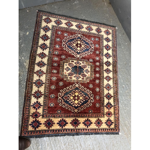 336 - A red and gold patterned rug 105x136