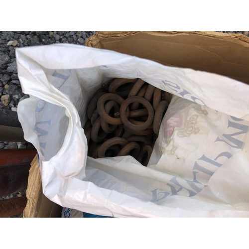 34 - An assortment of curtain poles and a box of rings and fittings