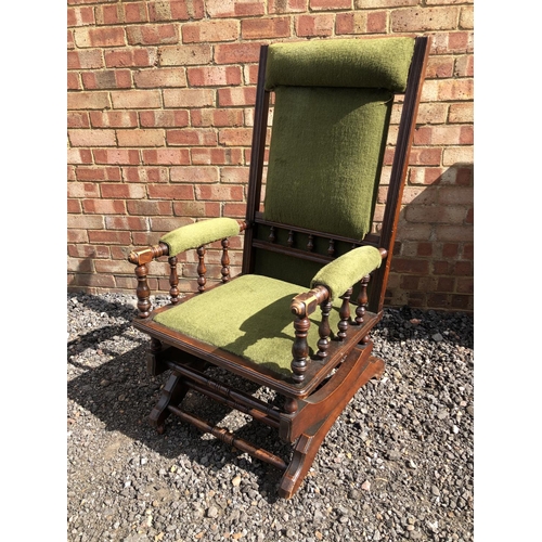 360 - An American spring rocking chair with green upholstery