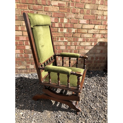 360 - An American spring rocking chair with green upholstery