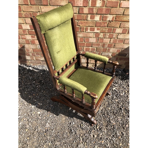 360 - An American spring rocking chair with green upholstery