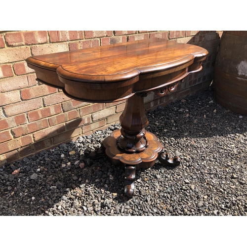 365 - A Victorian rosewood fold over tea table on a single bolster support