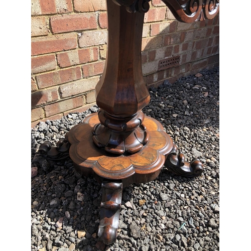 365 - A Victorian rosewood fold over tea table on a single bolster support