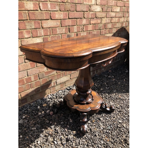 365 - A Victorian rosewood fold over tea table on a single bolster support