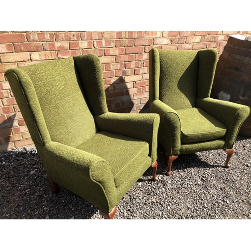 366 - A pair of green upholstered Parker Knoll style in chairs