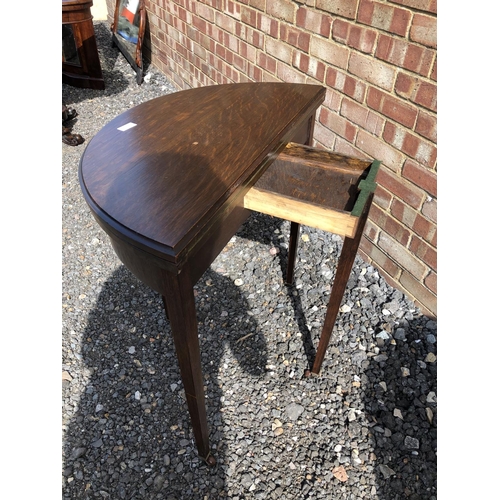 368 - A Demi lune oak fold over card table, with a telescopic leg sliding to support the green baize playi... 