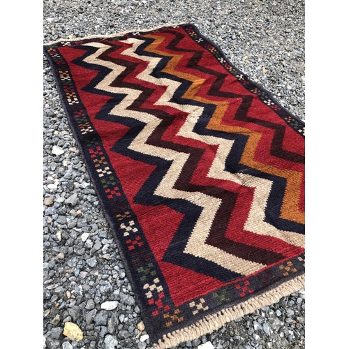 379 - A bright red oriental Patterned rug 133x76