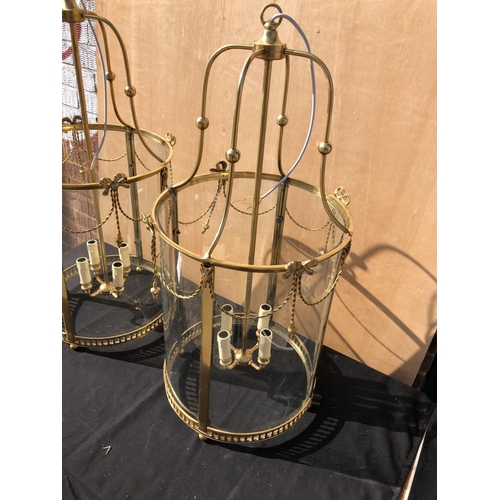 384 - A pair of large brass circular handing lantern light fittings wired for use 84cm high