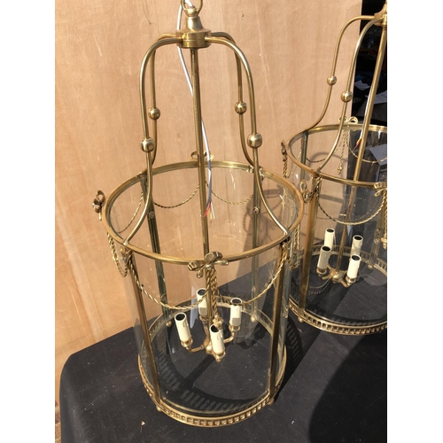 384 - A pair of large brass circular handing lantern light fittings wired for use 84cm high