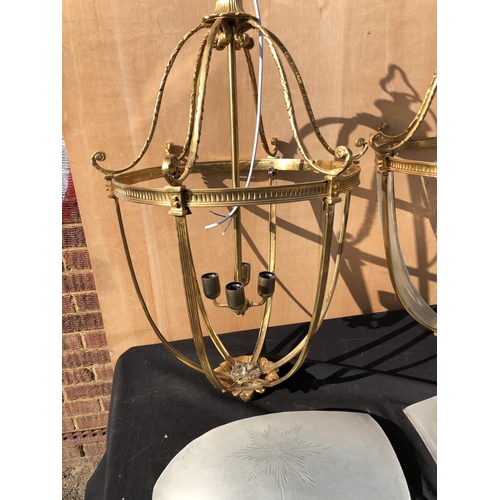 385 - A pair of large brass hanging light fittings with smoked glass sections (some glass loose & broken)