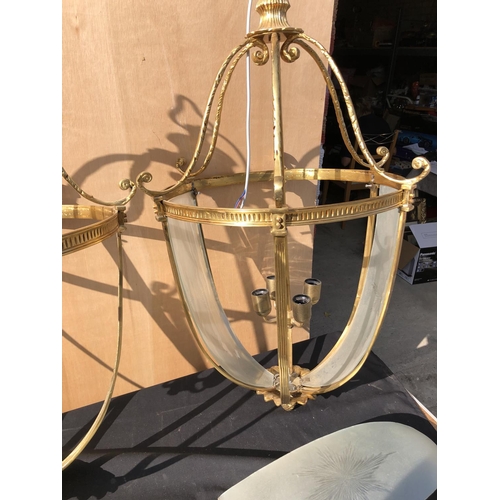 385 - A pair of large brass hanging light fittings with smoked glass sections (some glass loose & broken)