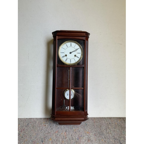 453 - Cased modern wall clock, approx 57cm tall with key and pendulum