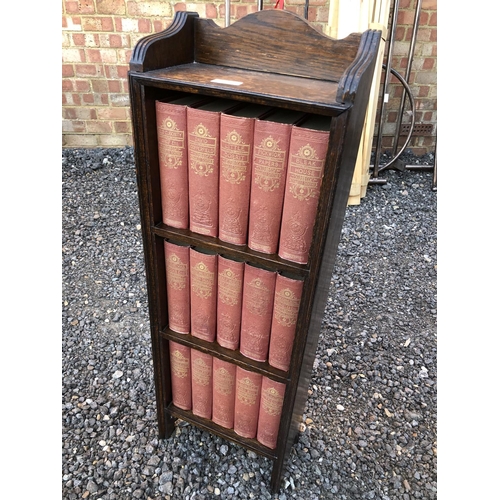 52 - A small oak bookcase containing a set of 15 Dickens books