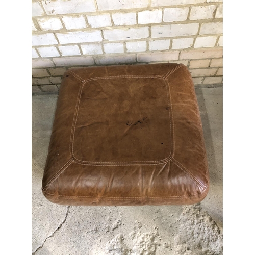 69 - A tan brown leather footstool