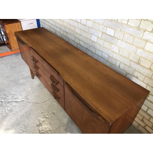 77 - A mid century teak sideboard by beautility, housing four drawers between two cupboards 184x46x76