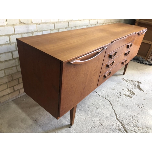 77 - A mid century teak sideboard by beautility, housing four drawers between two cupboards 184x46x76