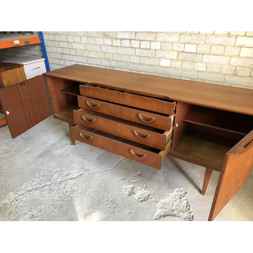 77 - A mid century teak sideboard by beautility, housing four drawers between two cupboards 184x46x76