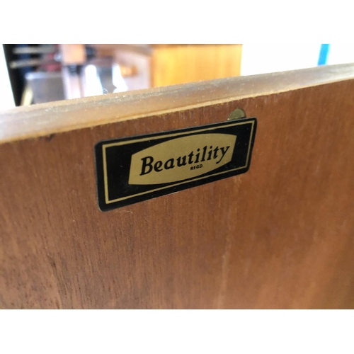 77 - A mid century teak sideboard by beautility, housing four drawers between two cupboards 184x46x76