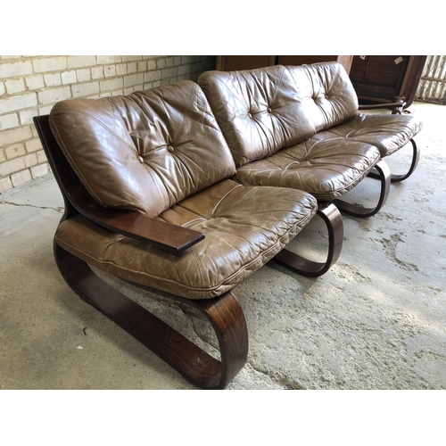 81 - A Swedish designer mid century couch with tan brown leather cushions