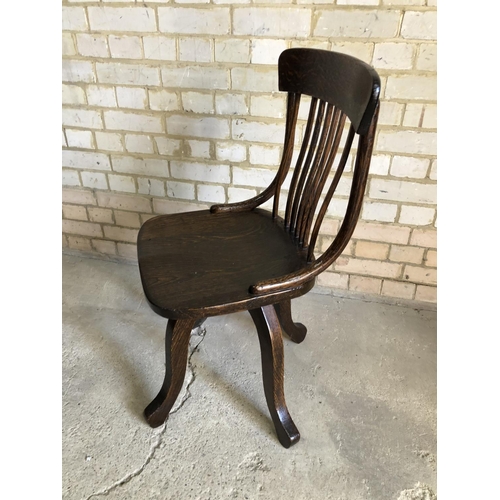 84 - An oak revolving desk chair