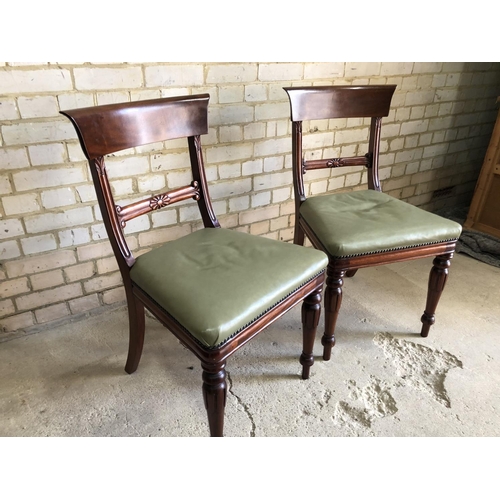 86 - A pair of Mahogany bar back dining chairs with green leather upholstered seats