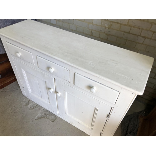 89 - A painted pine dresser base / counter with three drawers over two cupboard base 142x44x99