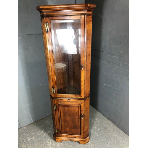 58 - A reproduction oak corner cabinet